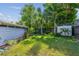 Lush green backyard featuring a well-maintained lawn, shed, and mature trees for privacy and shade at 7000 14Th N St, St Petersburg, FL 33702