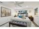 Bedroom with hardwood floors, lots of pillows, neutral colors, and bench at the end of the bed at 7000 14Th N St, St Petersburg, FL 33702