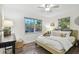 Comfortable bedroom features hardwood floors, neutral decor, and lots of natural light at 7000 14Th N St, St Petersburg, FL 33702