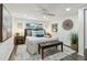 Bedroom featuring hardwood floors, neutral decor, lots of pillows, and bench at the end of the bed at 7000 14Th N St, St Petersburg, FL 33702