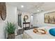 Bedroom with hardwood floors, lots of pillows, view of entry and bathroom, and plant at 7000 14Th N St, St Petersburg, FL 33702