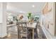 Bright dining area with hardwood flooring, contemporary art, and an open view to the living room at 7000 14Th N St, St Petersburg, FL 33702