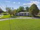 Charming home with a well-manicured lawn, mature trees, and a curved driveway enhances curb appeal at 7000 14Th N St, St Petersburg, FL 33702