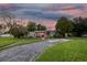 Charming single-story home featuring a vibrant red door and a well-manicured green lawn at 7000 14Th N St, St Petersburg, FL 33702