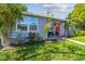 Charming home with a red front door, manicured lawn, and inviting curb appeal at 7000 14Th N St, St Petersburg, FL 33702