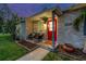 Inviting front porch with brick accents, seating, and landscaped garden, perfect for enjoying the outdoors at 7000 14Th N St, St Petersburg, FL 33702
