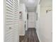 Hallway with wood floors, neutral walls, and built-in storage cabinets at 7000 14Th N St, St Petersburg, FL 33702
