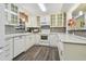 Bright kitchen with white cabinetry, modern appliances, and a stylish backsplash at 7000 14Th N St, St Petersburg, FL 33702