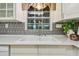 Close-up of kitchen sink with modern faucet, granite countertop, and window view at 7000 14Th N St, St Petersburg, FL 33702