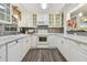 Bright kitchen with white cabinets, stainless steel appliances, and ample counter space at 7000 14Th N St, St Petersburg, FL 33702