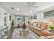 Bright living room featuring wicker furniture, a ceiling fan, and natural light from the windows at 7000 14Th N St, St Petersburg, FL 33702