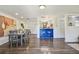 Open-concept living and dining area featuring hardwood floors and a stylish breakfast bar at 7000 14Th N St, St Petersburg, FL 33702