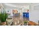 Spacious open-concept living area with hardwood floors connecting the living, dining, and kitchen spaces at 7000 14Th N St, St Petersburg, FL 33702
