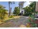 Spacious backyard featuring mature trees and landscaping, perfect for outdoor entertaining at 725 85Th N Ave, St Petersburg, FL 33702