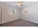 Simple bedroom with neutral walls, plush carpeting, and bright natural light from the window at 725 85Th N Ave, St Petersburg, FL 33702