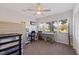 Well-lit bedroom featuring a ceiling fan, large window, and ample space for relaxation and hobbies at 725 85Th N Ave, St Petersburg, FL 33702