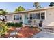 Close up of the front of the home showing the entry way, light fixtures, and front yard at 725 85Th N Ave, St Petersburg, FL 33702