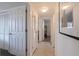 Bright hallway with neutral walls, multiple doorways, and stylish flooring leading to various rooms at 725 85Th N Ave, St Petersburg, FL 33702