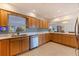 This kitchen features wood-colored cabinets, a stainless steel dishwasher, and a stainless steel sink at 725 85Th N Ave, St Petersburg, FL 33702