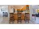 This eat-in kitchen features seating at the counter and light, modern wood cabinetry at 725 85Th N Ave, St Petersburg, FL 33702