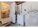 Practical laundry area with modern washer, dryer, storage cabinets, and easy access to the kitchen at 725 85Th N Ave, St Petersburg, FL 33702