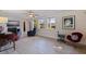 Cozy living room features modern decor, stylish furniture, white brick accent wall and natural light at 725 85Th N Ave, St Petersburg, FL 33702