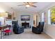 Living room with brick wall, ceiling fan, comfortable seating and lots of natural light at 725 85Th N Ave, St Petersburg, FL 33702