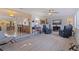 Open-concept living area features modern furniture, brick accent wall, and seamless flow to the kitchen at 725 85Th N Ave, St Petersburg, FL 33702