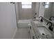 Bathroom featuring a double vanity with granite countertop and a tub shower combo at 7534 Mako Dr, Hudson, FL 34667