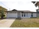 Single-story home featuring a fresh white paint job and a two-car garage at 7534 Mako Dr, Hudson, FL 34667
