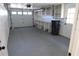 Clean, organized garage with shelving, lighting, and a utility door at 7534 Mako Dr, Hudson, FL 34667