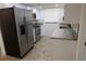 Galley kitchen featuring stainless steel appliances, granite countertops, and white cabinets at 7534 Mako Dr, Hudson, FL 34667