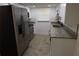 Galley kitchen featuring stainless steel appliances, granite countertops, and white cabinets at 7534 Mako Dr, Hudson, FL 34667