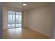 Open concept living room featuring tile flooring and access to a screened in porch at 7534 Mako Dr, Hudson, FL 34667
