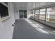 Sunroom with lots of windows overlooking the yard, accessible via a sliding glass door at 7534 Mako Dr, Hudson, FL 34667
