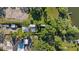 Aerial view of a lakeside property with mature trees and a private pool at 8020 Sharon Dr, Tampa, FL 33617