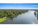 Breathtaking aerial view of a wide river surrounded by lush greenery, showcasing serene waterfront living and natural beauty at 8020 Sharon Dr, Tampa, FL 33617
