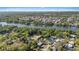 Aerial view of a riverfront community with a pool and tree-lined streets, near Bush Gardens, offering privacy and convenience at 8020 Sharon Dr, Tampa, FL 33617