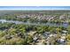 Overhead view of a riverfront community with a pool and tree-lined streets, offering privacy and a serene setting at 8020 Sharon Dr, Tampa, FL 33617
