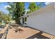 Lovely wood back deck with sliding glass doors and railing overlooking tranquil yard at 8020 Sharon Dr, Tampa, FL 33617