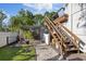 The backyard boasts a charming screen enclosure and stairs to the second story deck at 8020 Sharon Dr, Tampa, FL 33617