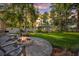 Lovely backyard with a stone fire pit and Adirondack chairs, perfect for entertaining at 8020 Sharon Dr, Tampa, FL 33617