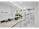 Modern bathroom with double vanity, marble countertop, and large walk-in shower at 8020 Sharon Dr, Tampa, FL 33617