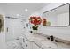 Bathroom features a double vanity, large mirror, and walk-in shower with glass door at 8020 Sharon Dr, Tampa, FL 33617