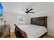 Traditional bedroom featuring a large bed, detailed wood furniture, and a ceiling fan at 8020 Sharon Dr, Tampa, FL 33617