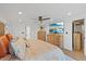 Bright bedroom with wood floors, dresser, ceiling fan and a large television at 8020 Sharon Dr, Tampa, FL 33617