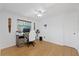 Bright bedroom with wood-look floors features a ceiling fan and home office setup at 8020 Sharon Dr, Tampa, FL 33617