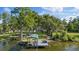 Private dock with boat lift on a tranquil, tree-lined waterway, perfect for boating enthusiasts and waterfront living at 8020 Sharon Dr, Tampa, FL 33617