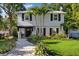 Charming two-story home featuring a manicured front yard, paver walkway, and inviting entrance at 8020 Sharon Dr, Tampa, FL 33617