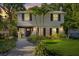 Charming two-story home featuring a manicured front yard, paver walkway, and inviting entrance at 8020 Sharon Dr, Tampa, FL 33617